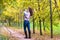 Young mother walking with her baby in autumn park