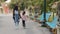 Young mother walking with little daughter in city park on weekend friendly cheerful african american family going