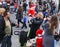 Young mother walking with little Santa Claus on Christmas market