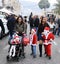 Young mother walking with little Santa Claus on Christmas market