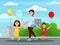 Young mother walking in park with her children. Buildings and bushes on background. Boy and girl holding balloons in