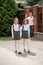 Young mother waving with hand to her daughters going to school