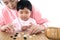 Young mothers teach their children to play go