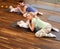 Young mothers and their babies doing yoga exercises on rugs at fitness studio.