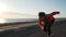 Young motivated girl is preparing to run on promenade at sunsetin nature.