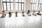 Young motivated mixed race people sitting in forward bend pose.