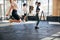 Young motivated women using ropes for skipping at gym