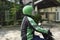 Young motorcycle taxi driver with green helmet