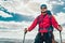 Young mountaineer standing with backpack