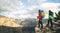 Young mountaineers standing with backpack on top of a mountain