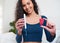 A young multi-ethnic woman holds tampon and menstrual cup for comparison choice
