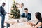 young multicultural businesspeople working and decorating christmas tree