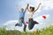 Young Multiethnic Couple Jumping In Poppy Field