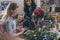 Young multiethnic florists working with flowers and digital tablet in flower shop