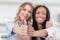 Young multiethnic waitresses smiling and showing thumbs up