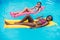 Young multiethnic women floating on inflatable mattresses in swimming pool