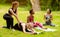 Young multinational girls practicing yoga with trainer during outdoor class at park