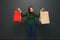 Young multinational women weigh bags with purchases