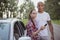 Young multiracial couple with a broken car in the middle of the road