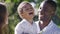 Young multiracial family in the park. Mother father and little boy are happy together.