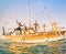 Young multiracial friends jumping from wooden sailboat