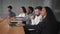 Young multiracial office workers watching presentation employees smiling nod approvingly listening lecture in boardroom