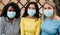 Young multiracial women wearing protective masks during coronavirus outbreak - Social distance between friends concept - Main