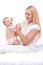 Young mum holding small baby. beautiful blond sitting on bed and smiling