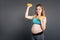 Young mummy holding yellow dumbbells
