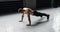 Young muscular athlete doing suspension pushups