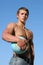 Young Muscular Athlete with a Globe