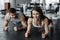 Young muscular couple doing doing hard workout at the gym. Doing plank in the gym