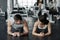 Young muscular couple doing doing hard workout at the gym. Doing plank in the gym
