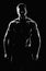 Young muscular fit sportsman posing shirtless on black backgroun