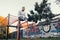 Young muscular good looking man working out on his abs using the horizontal ladder and parallel bars station