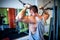 young, muscular man, bodybuilder working out in gym