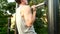 Young muscular man doing pull ups on a bar in park