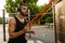 Young muscular man doing workout with fitness rubber bands outdoors