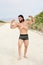 Young muscular man exercising on the beach, young muscular man doing bodibuilding exercises on the beach, athletic young man posin