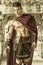 Young muscular man posing in gladiator costume