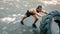 Young muscular man pushing large tire