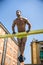 Young muscular man shirtless exercising outdoors