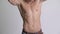 Young muscular shirtless man flexing abs