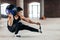 Young muscular sportsman working out with medicine ball at gym