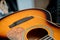 Young musician changing strings on a classical guitar in a guitar shop