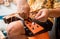 Young musician changing strings on a classical guitar in a guitar shop