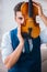 The young musician man practicing playing violin at home