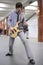 Young musician play on guitar at metro station