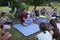 Young musician playing Indian percussion instrument Mridangam for meditation, group of people listening