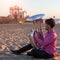 Young musician playing the trumpet on the sea coast. Tuba instrument.